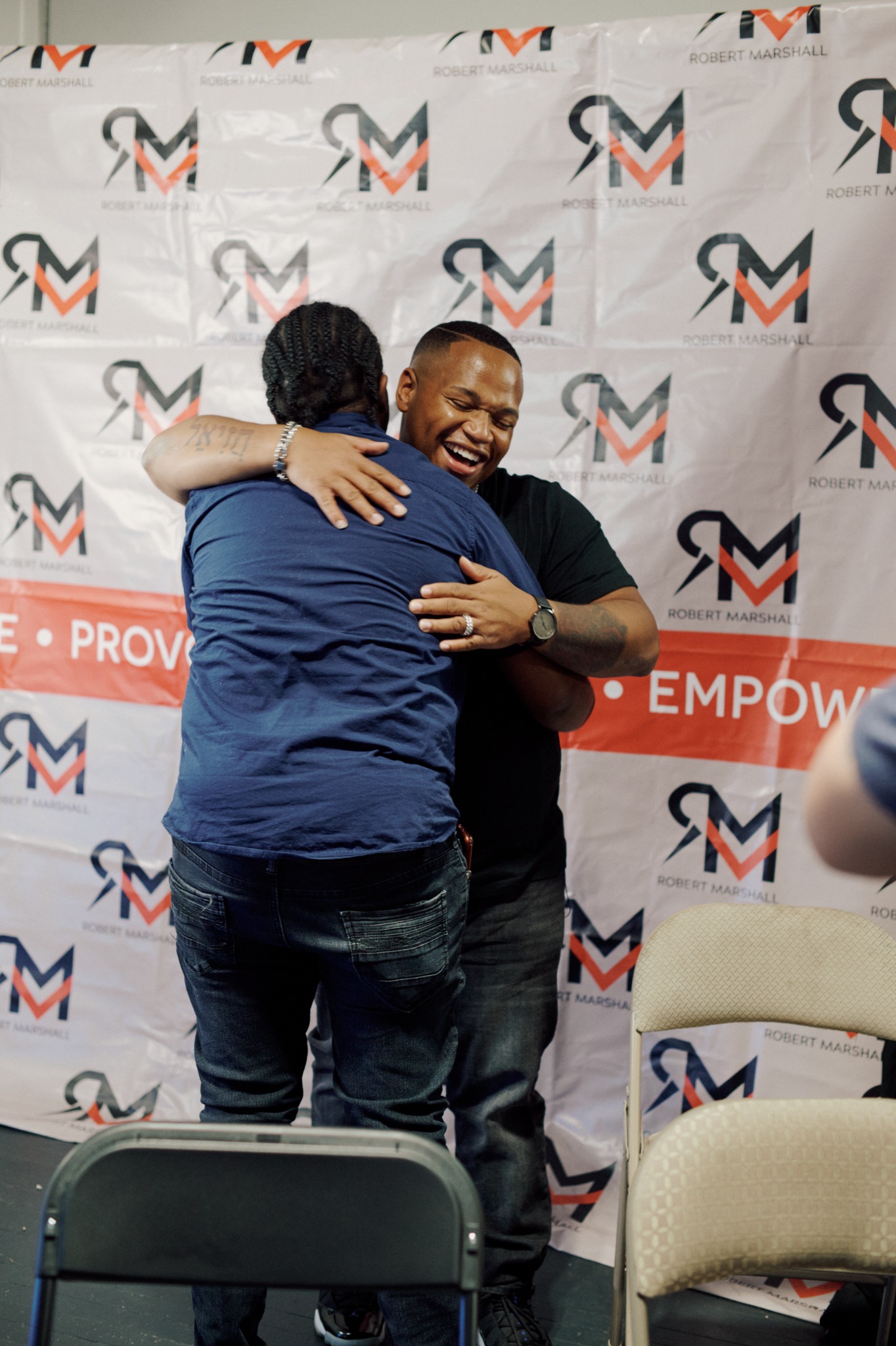 Robert H. Marshall Jr. warmly embracing a participant