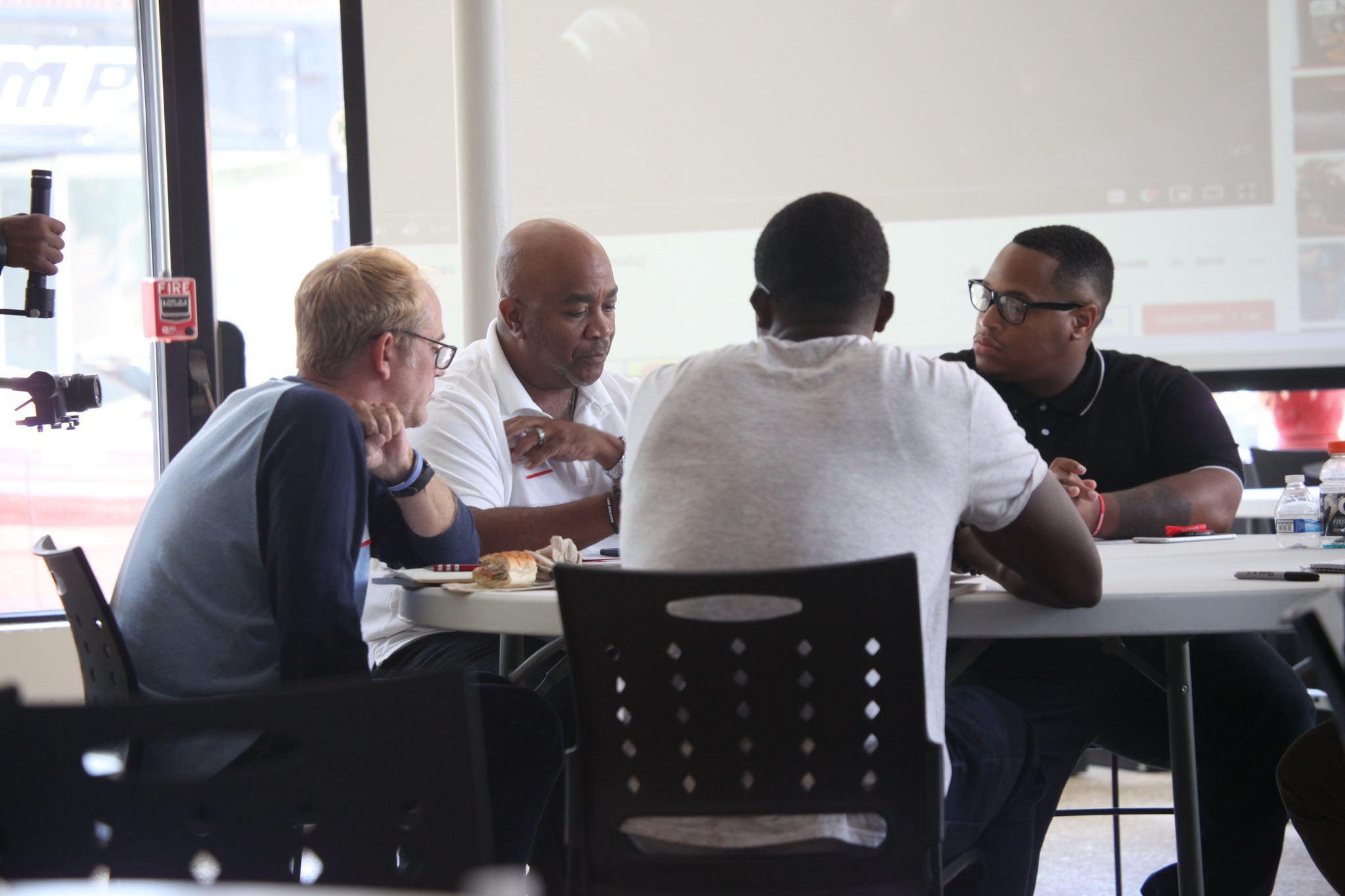 Men in a small-group conversation with Robert H. Marshall Jr.