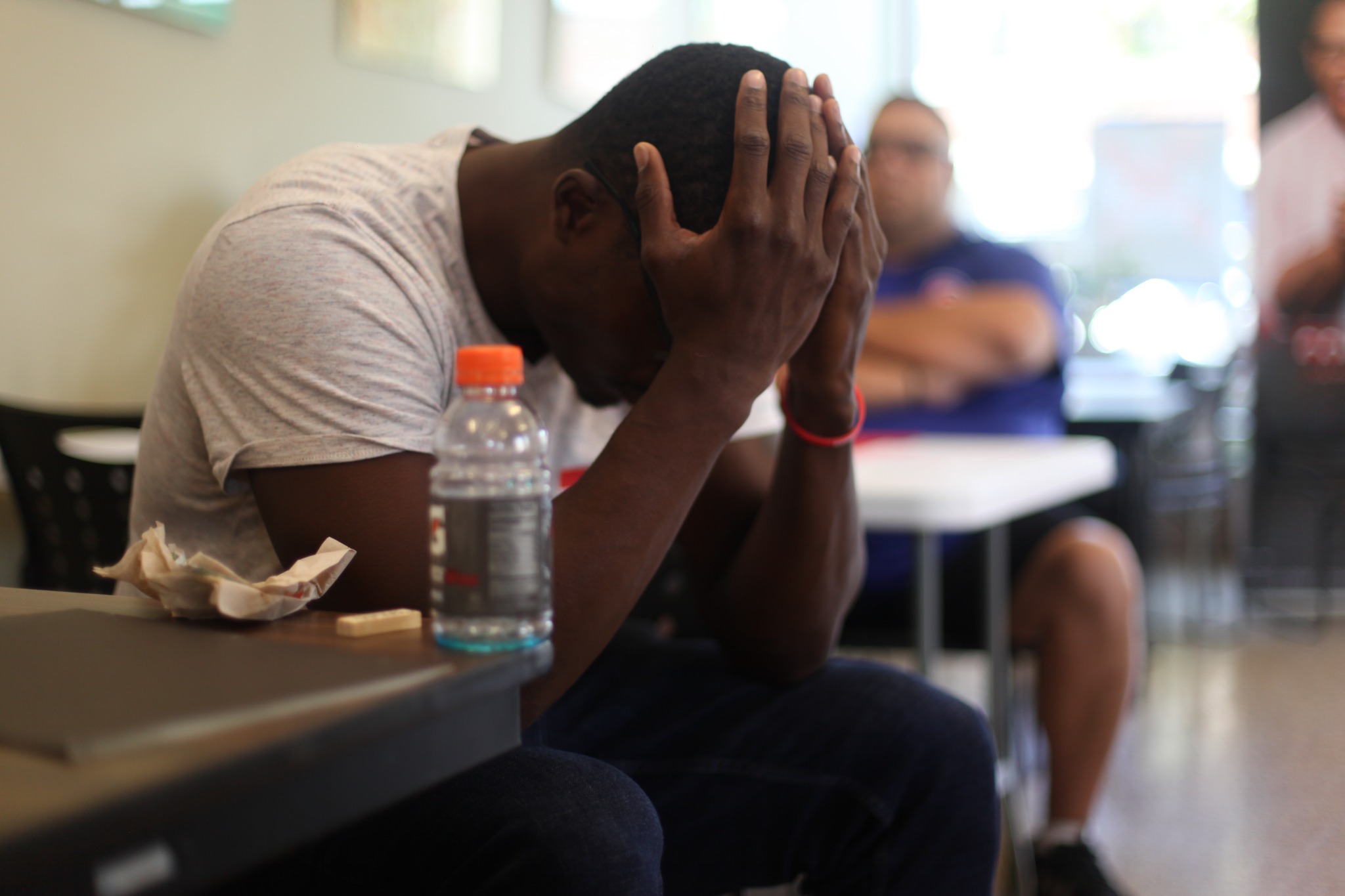 A participant in a vulnerable moment during a men's healing gathering